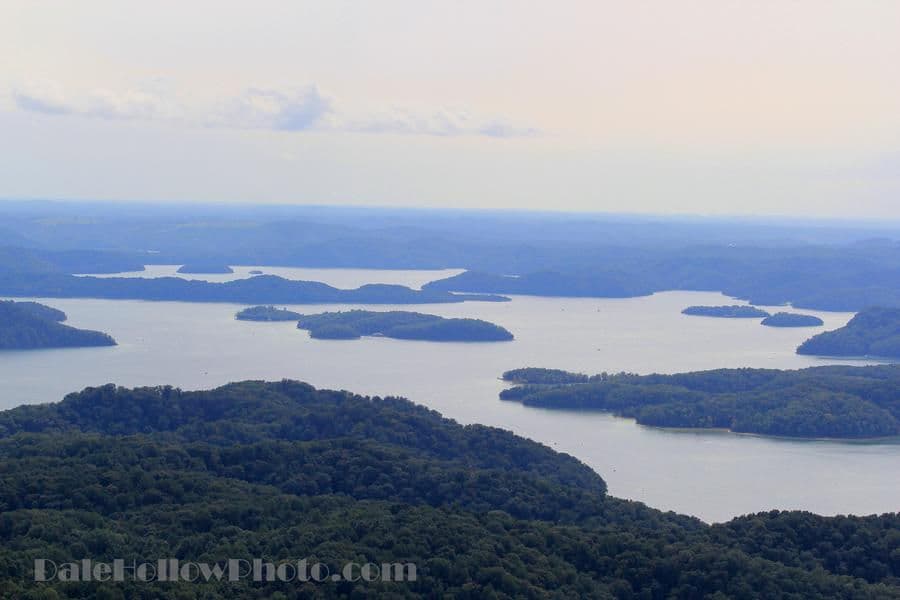 Green hills jutting out from the vast blue waters creates a scenic view