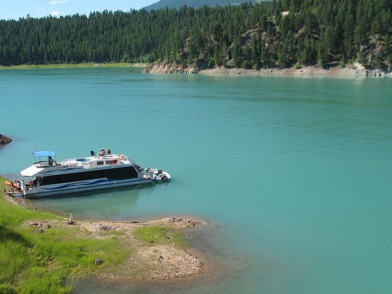 Bright blue waters surrounded by deep green forests at Koocanusa