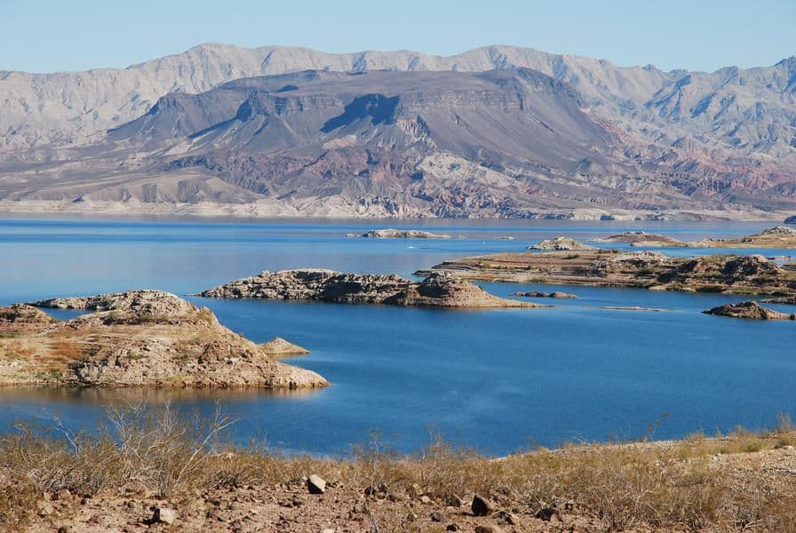 Towering desert mountains offer a unique view against the blue waters