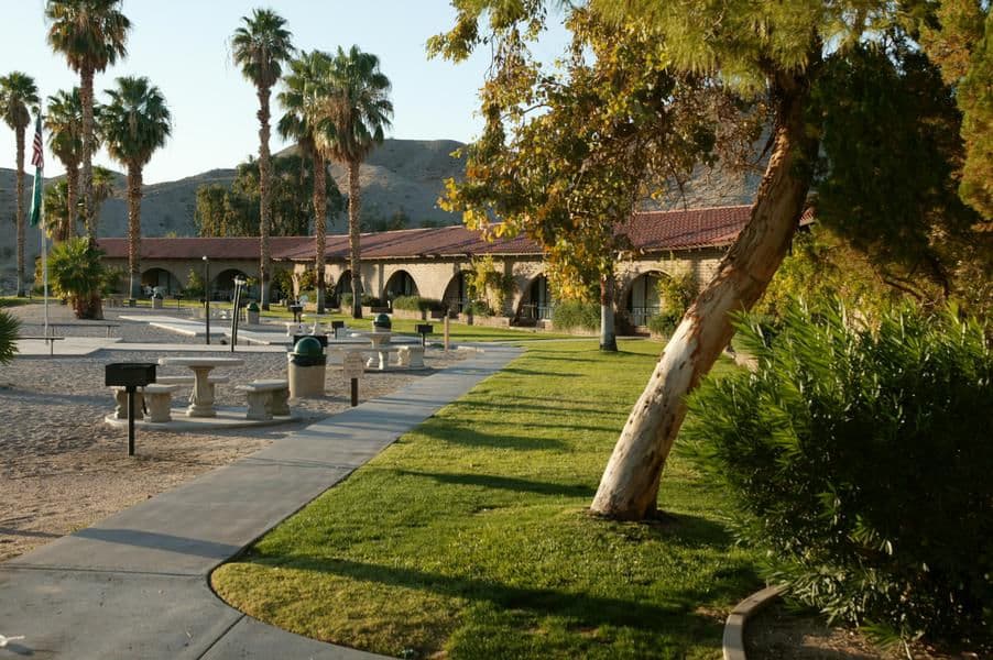 Stroll pass green grass and white sands on your way to the marina