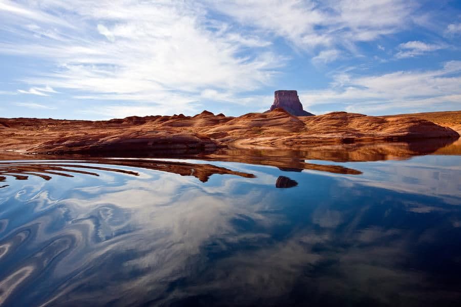 Glassy water merges with the stunning scenery