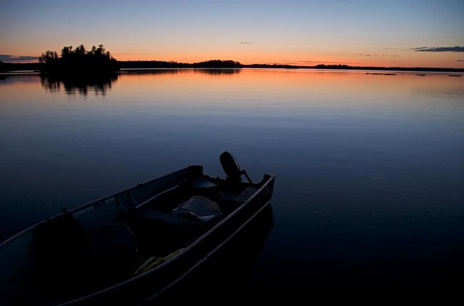 An almost faded sun over the glassy water