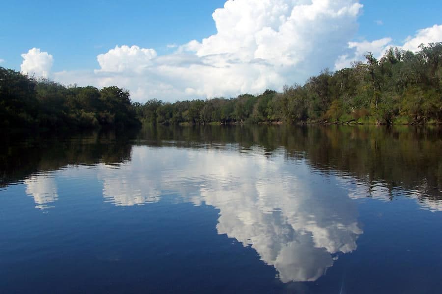 The rippling waters of the river catch a stunning blue sky