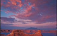 Deep blue water contained within orange-red cliff walls