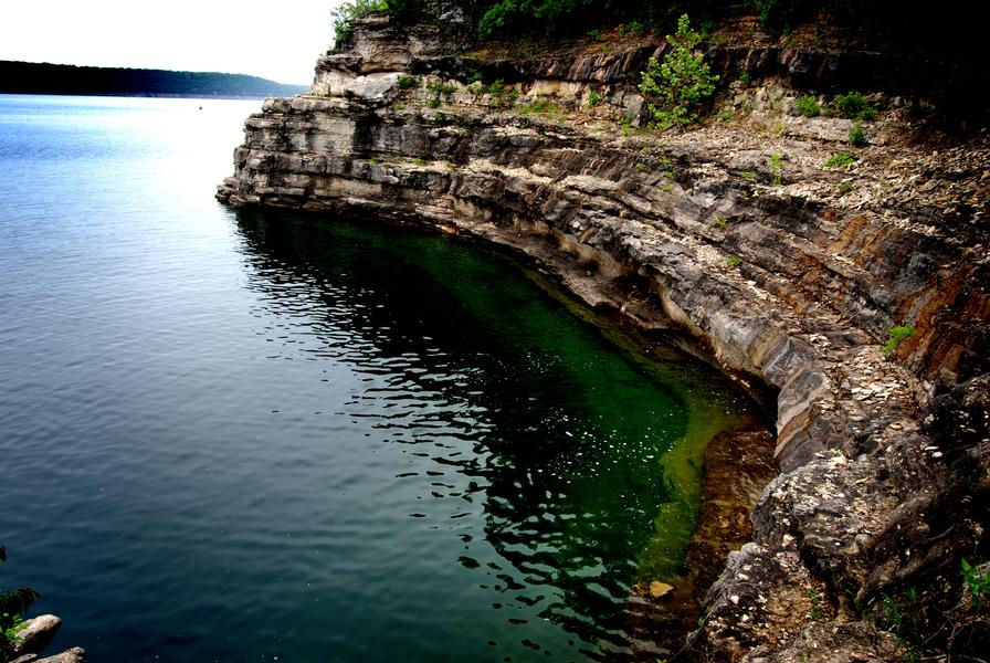 Beautiful rock formation extending into the clear water