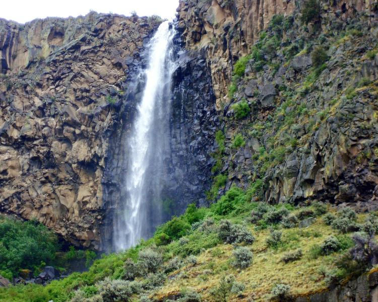 A waterfall is a stunning sight at a desert lake