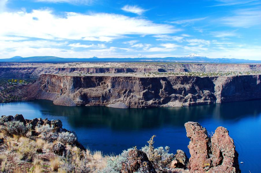 The blue water is a striking contrast to the almost barren land