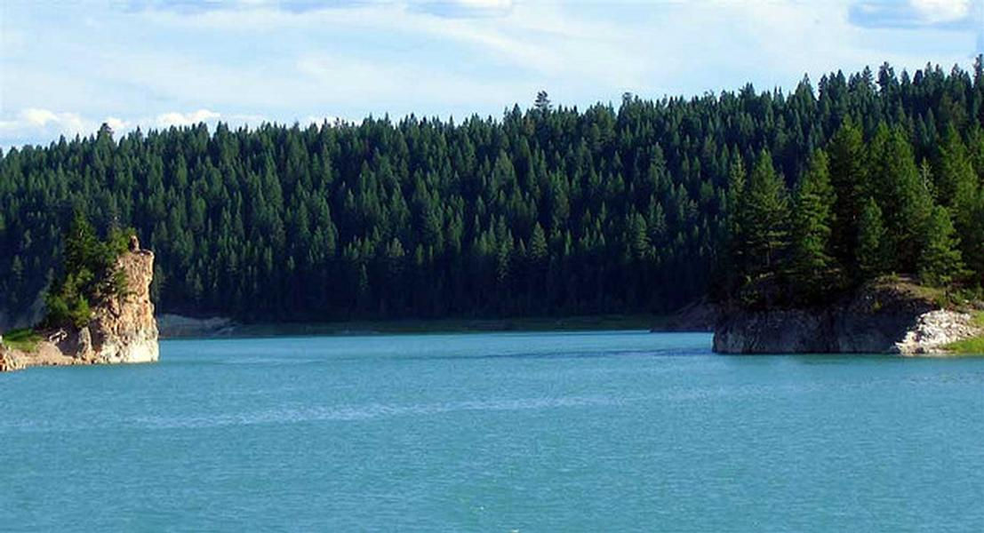 Stunning blue water against a green backdrop