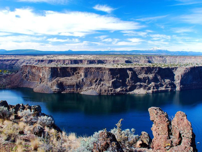 The blue water is a striking contrast to the almost barren land Photos