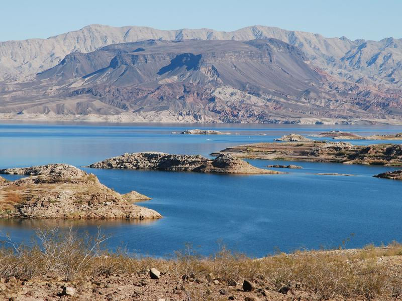 Towering desert mountains offer a unique view against the blue waters Photos